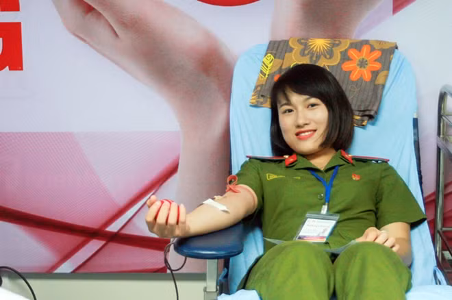 A young fire fighting police officer donating her blood for poor patients. A young fire fighting police officer donating her blood for poor patients.