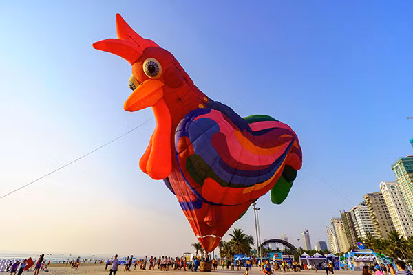 A giant rooster looks down on beach goers. These hot air balloons recently participated in Hue International Hot Air Balloon Festival 2019 held April 27-29 under the framework of the Hue Traditional Craft Festival.