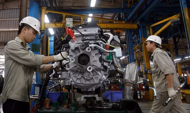 Men work with an engine at automaker Ford Vietnam's factory in Vietnam's northern Hai Duong Province. Photo by Reuters