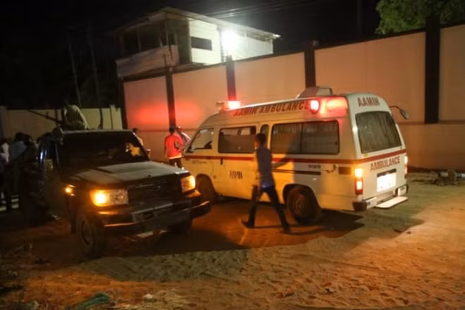 A man walks past an ambulance and armed security forces at the scene of an attack outside an hotel in Mogadishu, Somalia June 14, 2017. REUTERS/Stringer