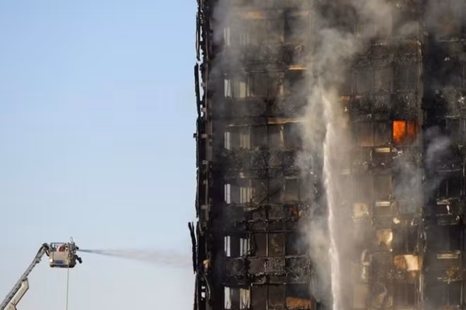 Firefighters deal with a serious fire in a tower block at Latimer Road in West London, Britain June 14, 2017. REUTERS/Toby Melville