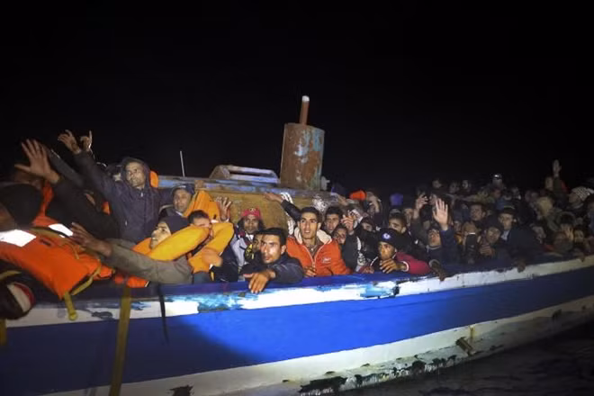 Migrants are seen onboard a drifting overcrowded wooden boat, during a rescue operation by the Spanish NGO Proactiva Open Arms, north of the Libyan city of Sabratha in central Mediterranean Sea, March 29, 2017. REUTERS/Yannis Behrakis