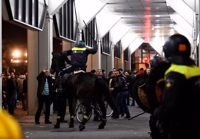 Riot police clash with demonstrators in the streets near the Turkish consulate in Rotterdam, Netherlands March 12, 2017. REUTERS/Dylan Martinez