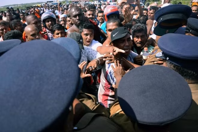 FILE PHOTO: Demonstrator shout at police officers at a protest against the launching of a $5 billion Chinese investment zone by China Merchants Port Holdings Company, in Mirijjawila, Sri Lanka January 7, 2017. REUTERS/Stringer/File Photo