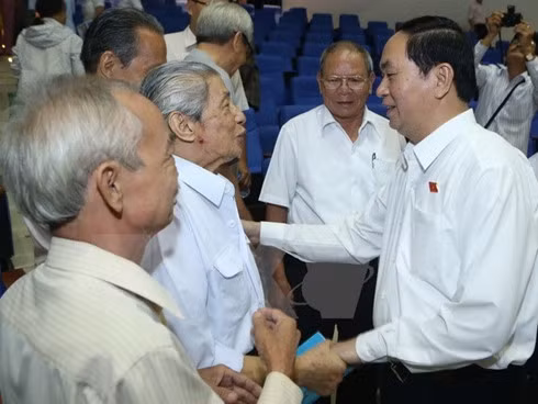 President Tran Dai Quang (R) at a meeting with voters.
