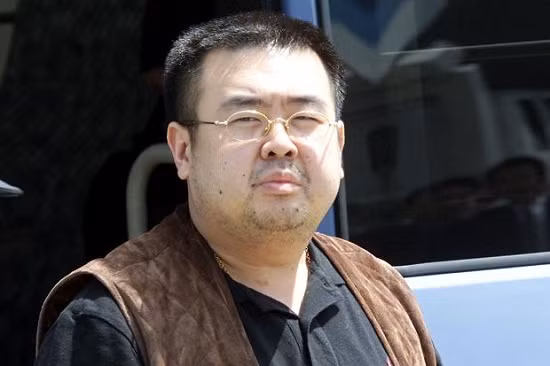 FILE PHOTO: A man (R) believed to be North Korean heir-apparent Kim Jong-nam is escorted by police as he boards a plane upon his deportation from Japan at Tokyo's Narita international airport May 4, 2001. REUTERS/Eriko Sugita/File Photo