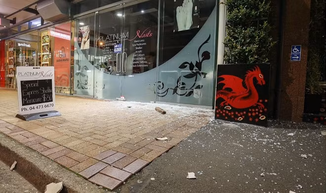 Broken glass and debris covers part of the road on Featherston Street after an earthquake in Wellington, New Zealand. Photo : Getty