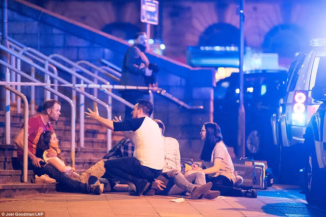 Concert goers react after fleeing the Manchester Arena in northern England where U.S. singer Ariana Grande had been performing in Manchester, Britain, May 22, 2017. REUTERS/Jon Super
