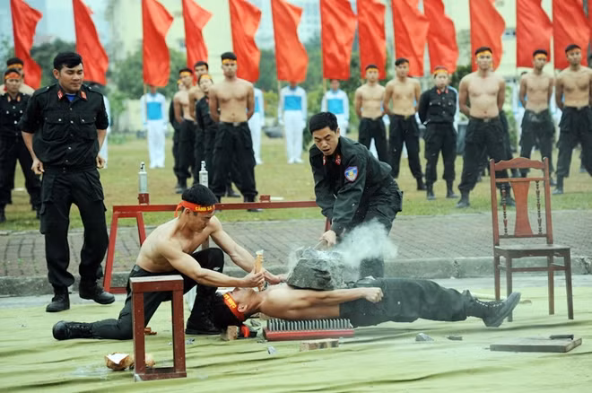 Breaking stone placed on the belly of an officer with a hammer.