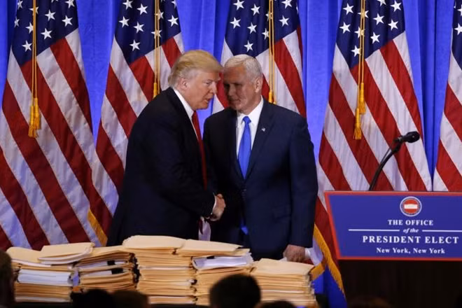 U.S. President-elect Donald Trump greets Vice President-elect Mike Pence during a news conference in the lobby of Trump Tower in Manhattan, New York City, U.S. on January 11, 2017. REUTERS/Lucas Jackson/File Photo