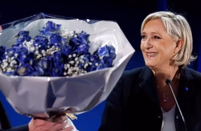 Marine Le Pen, French National Front (FN) political party leader and candidate for French 2017 presidential election, holds a bouquet of flowers as she celebrates after early results in the first round of 2017 French presidential election, in Henin-Beaumont, France, April 23, 2017. REUTERS/Pascal Rossignol