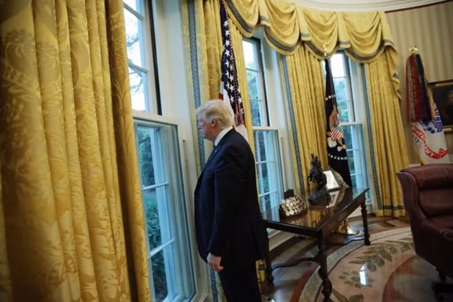 U.S. President Donald Trump looks out a window of the Oval Office following an interview with Reuters at the White House in Washington, U.S., April 27, 2017. REUTERS/Carlos Barria
