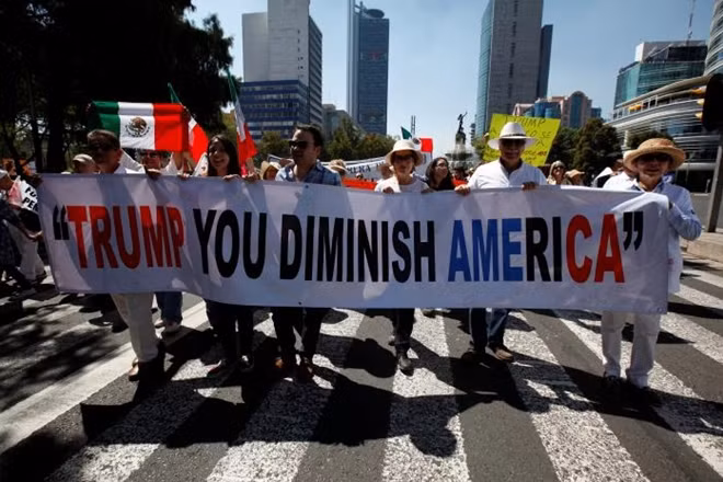 Demonstrators hold a banner during a march to protest against U.S. President Donald Trump's proposed border wall, and to call for unity, in Mexico City, Mexico, February 12, 2017. REUTERS/Jose Luis Gonzalez