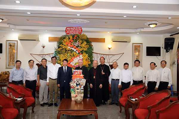Deputy Minister Bui Van Nam presents flowers and gifts to dignitaries of the Xuan Loc Diocese on the occasion ofthe 2019Christmas.