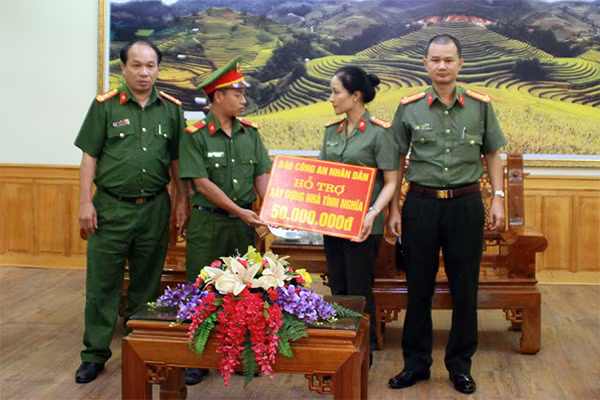 Colonel Nguyen Thuy Quynh handing 68 million VND to support policemen with economic difficulties in Tram Tau and Mu Cang Chai districts.