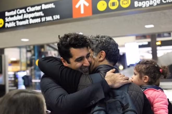 Iranian citizen and U.S green card holder Cyrus Khosravi (L) greets his brother, Hamidreza Khosravi (C), and niece, Dena Khosravi (R), 2, after they were detained for additional screening following their arrival to Seattle-Tacoma International Airport to visit Cyrus, during a pause in U.S. President Donald Trump's travel ban in SeaTac, Washington, U.S. February 6, 2017. REUTERS/David Ryder