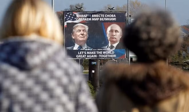 FILE PHOTO: A billboard showing a pictures of US president-elect Donald Trump and Russian President Vladimir Putin is seen through pedestrians in Danilovgrad, Montenegro, November 16, 2016. REUTERS/Stevo Vasiljevic/File Photo