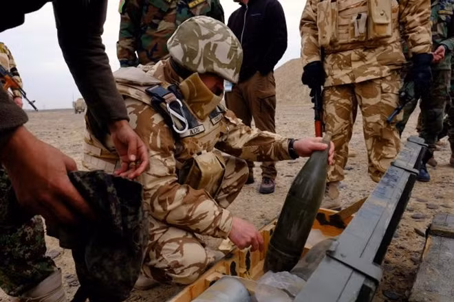 A Romanian military adviser inspects artillery shells before a live-fire exercise with Afghan troops outside Kandahar Air Field, Afghanistan, February 15, 2017. REUTERS/Josh Smith.