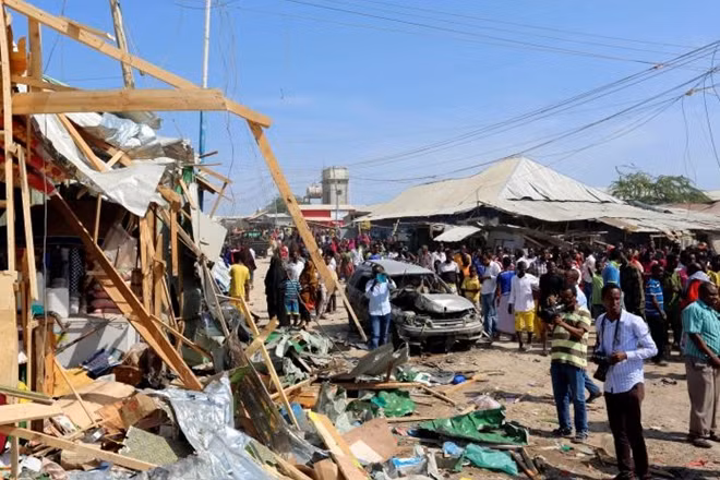 Civilians gather near the scene of a suicide bomb explosion at the Wadajir market in Madina district of Somalia's capital Mogadishu February 19, 2017. REUTERS/Feisal Omar.