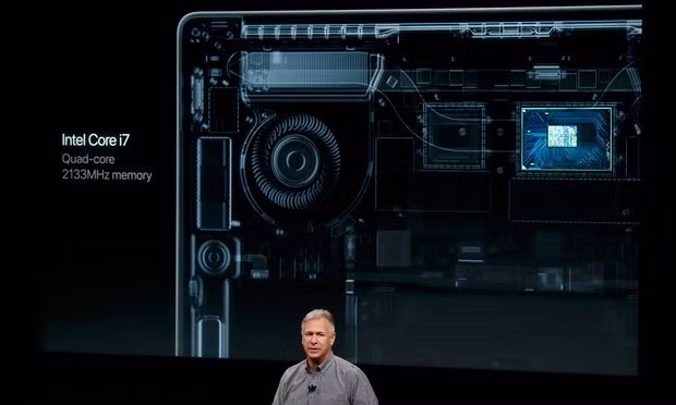 Schiller speaks under a graphic of the processor of a new 15in MacBook Pro during an Apple media event in Cupertino. Photograph: Beck Diefenbach/Reuters