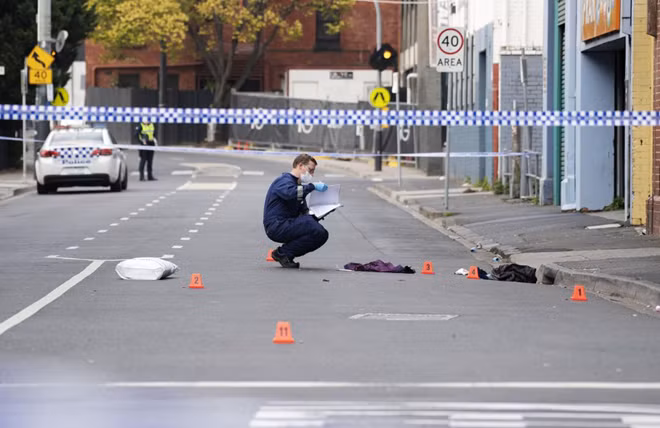 A Victoria Police personnel works at the scene of a multiple shooting outside Love Machine nightclub in Prahran, Melbourne, Australia April 14, 2019. AAP Image/Ellen Smith/via REUTERS