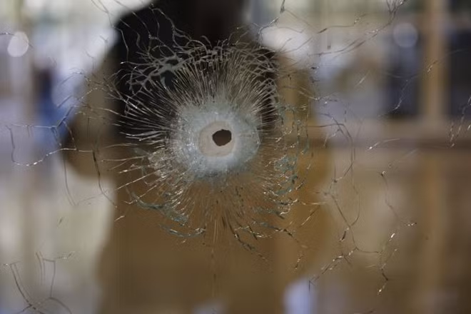 A damaged window is pictured on the Champs Elysees Avenue the day after a policeman was killed and two others were wounded in a shooting incident in Paris, France, April 21, 2017. REUTERS/Benoit Tessier
