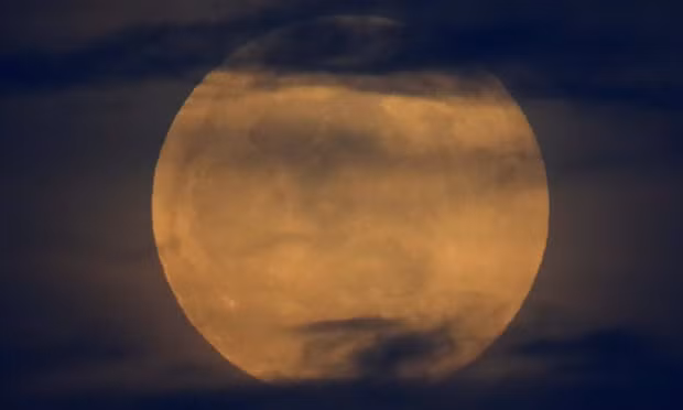Before the super blood wolf moon lunar eclipse, the full moon rises through the clouds in California. Photograph: Mike Blake/Reuters