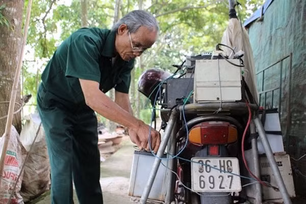 Man on a mission: Chieng prepares his bike before setting off. He drives about 10 to 15 kilometres every day to different communes of Trieu Son District.