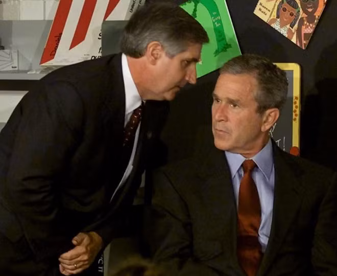 Then President George W. Bush listens as White House Chief of Staff Andrew Card informs him of a second plane hitting the World Trade Center while Bush was conducting a reading seminar at the Emma E. Booker Elementary School in Sarasota, Florida, September 11, 2001. REUTERS/Win McNamee
