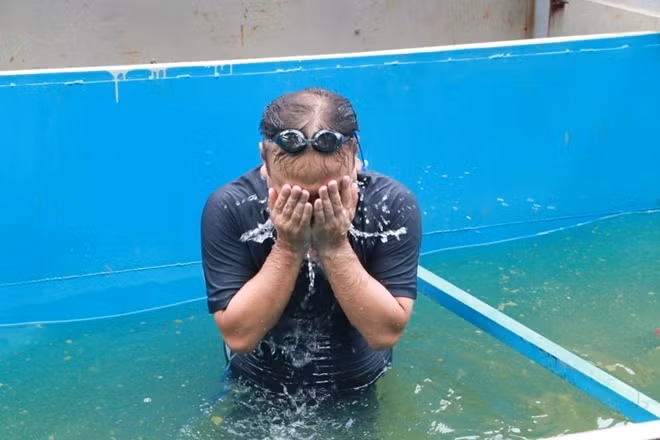 He bathes in the water-treated tank to prove the effectiveness of Nano tech.
