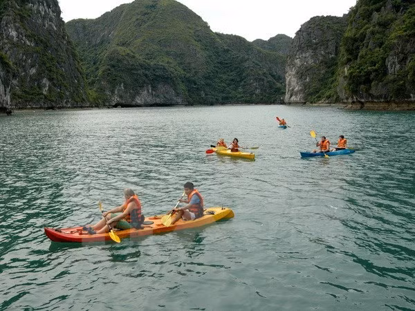 Tourists go kayaking on Ha Long Bay