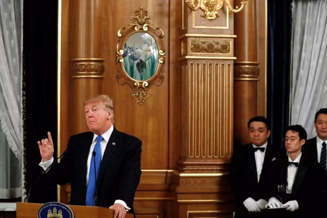 Waiters hold U.S. President Donald Trump's Diet Coke as he delivers remarks before his toast to Japan's Prime Minister Shinzo Abe during an official dinner in Trump's honor at Akasaka Palace in Tokyo, Japan November 6, 2017. REUTERS/Jonathan Ernst