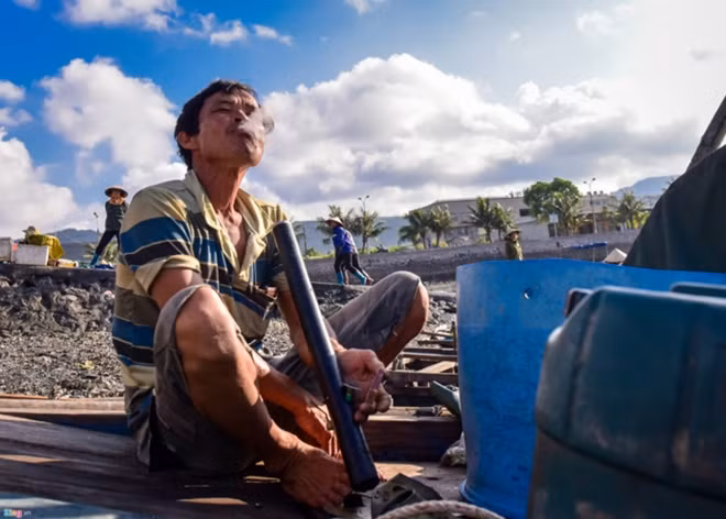 When women are busy at the market, their men take time to relax after their fishing trip.