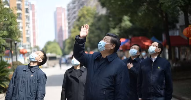 © Xie Huanchi/Xinhua/Zuma Press/TNS WUHAN, March 10, 2020 Chinese President Xi Jinping, center, along with the general secretary of the Communist Party of China Central Committee and chairman of the Central Military Commission, waves to residents who are quarantined at home and sends regards to them at a community in Wuhan, central China's Hubei Province, March 10, 2020.