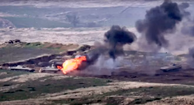 A still image from a video released by the Armenian Defence Ministry shows what is said to be Azerbaijani armoured vehicles, one of which is destroyed by Armenian armed forces in the breakaway region of Nagorno-Karabakh, in this still image from footage released September 27, 2020. Defence Ministry of Armenia/Handout via REUTERS