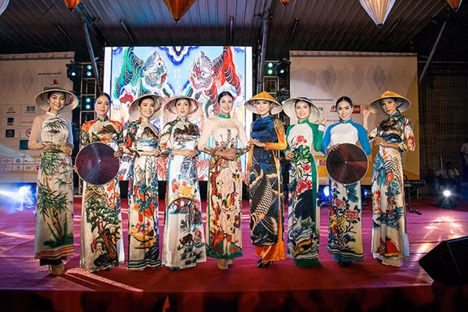 Patterns of rice fields, kites, and village bamboo in paintings by Pham Trinh are printed on every dress.