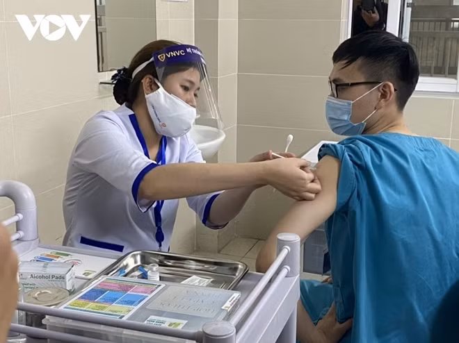 A medical worker receives a shot of the AstraZeneca vaccine