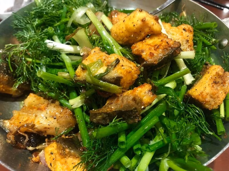 The fish is well-marinated in a mixture of spices including turmeric. Photo: Thuy An
