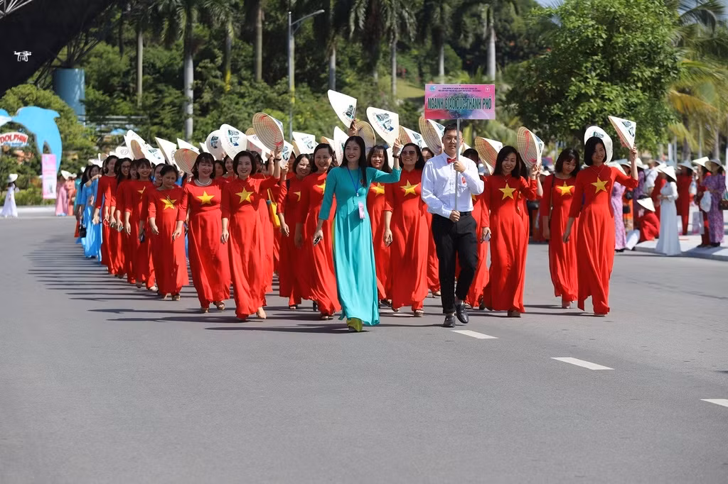 Teachers wear Ao Dai featuring national flags as they attend the street parade in Ha Long city in response to the celebratory week.