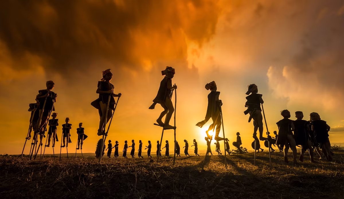 Phan Thi Khanh from Ho Chi Minh City wins second runners-up titles in categories such as Travel, Lifestyle, Documentary, Street, and Portrait. The image features a group of children playing at a traditional festival held in the Central Highland province of Gia Lai.