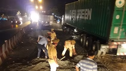 Traffic police force backfill sinkholes on the road