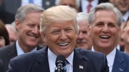 Softening his approach, Trump helps seal a healthcare deal