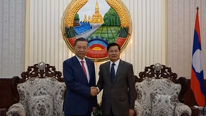 Minister To Lam visits Lao People's Democratic Republic