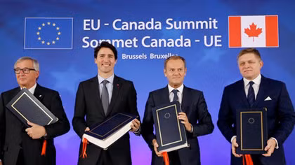 EU, Canada sign free trade deal but battle not over
