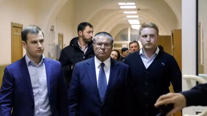 Russia's Putin fires economy minister over bribery charges