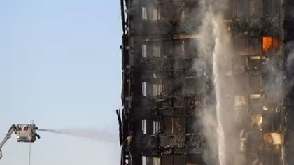 Fire engulfs London tower block, at least 12 dead, dozens injured