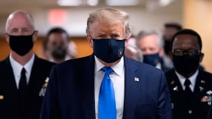 In a first, Trump dons masks in visit to a military medical facility