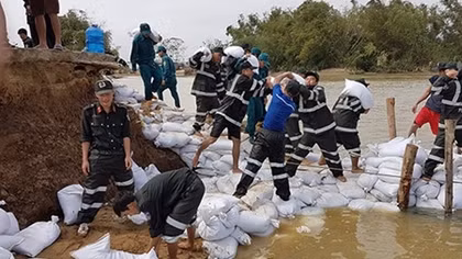 Police officers help people deal with floods during New Year Holiday 