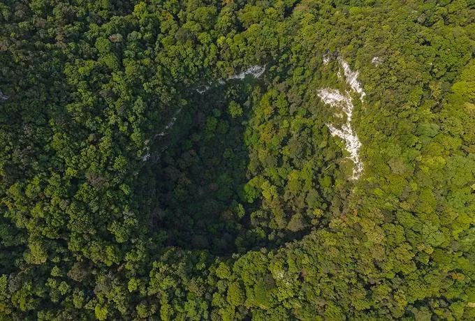 A 120-meter-deep sinkhole in Phong Nha-Ke Bang National Park seen from above. Photo by Jungle Boss