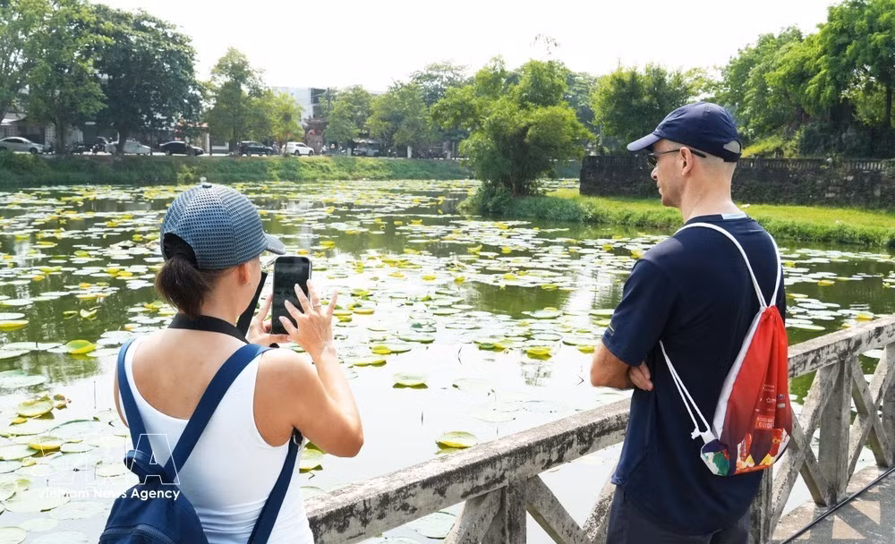 International tourists visiting Tinh Tam Lake in the Hue Imperial Citadel. (Photo: VNA)